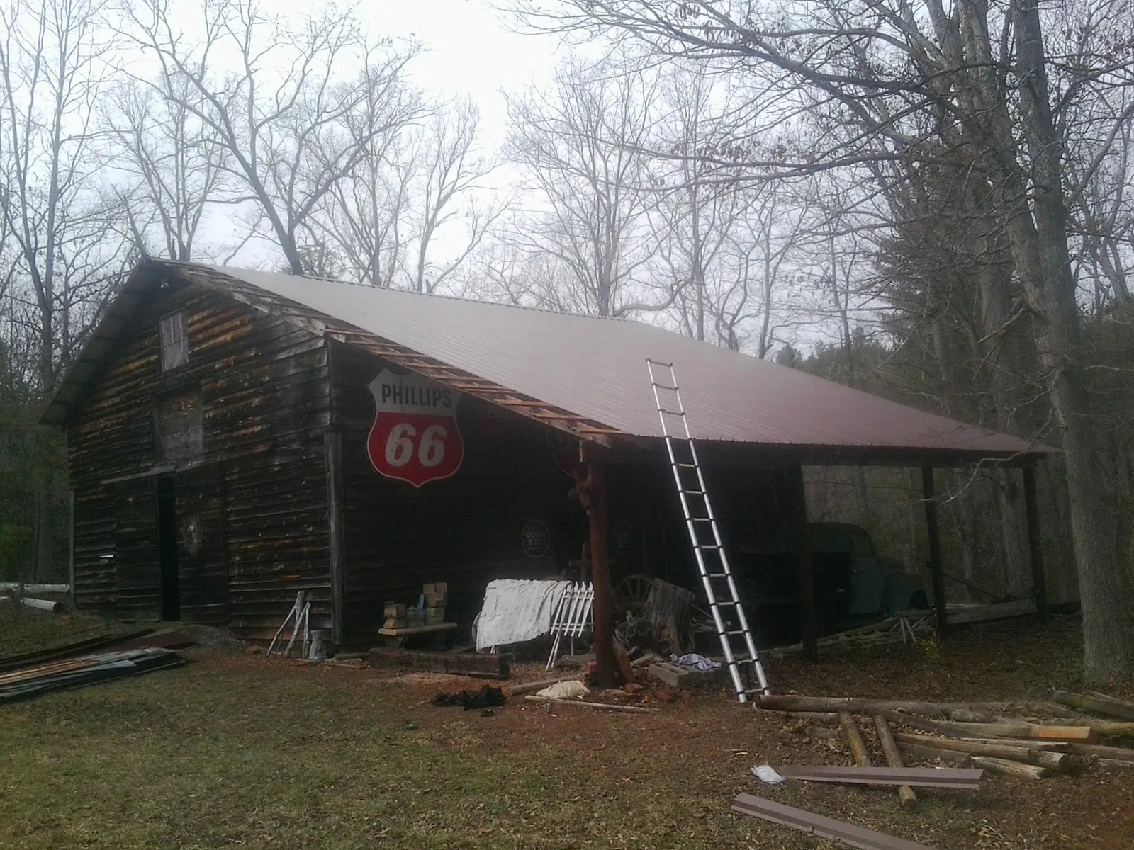 New metal roof on an open sided timber barn with a vintage sign in Caroleen